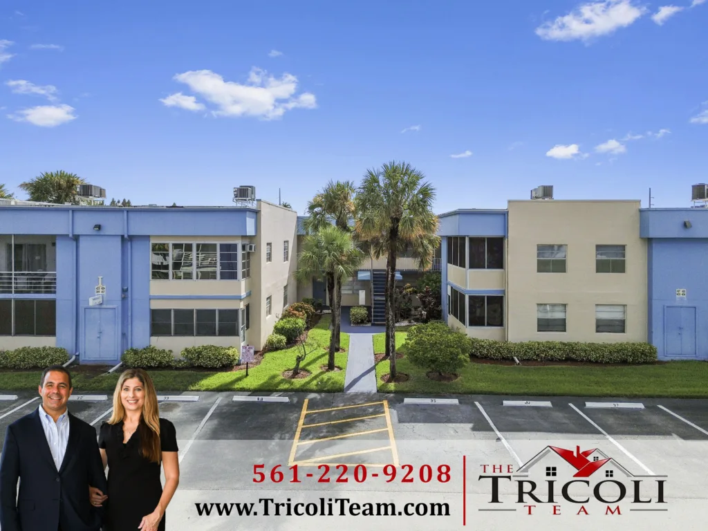 DCIM100MEDIADJI_0851JPG - Lake Worth Homes - Lake Worth Homes Real estate ad showing a blue-beige apartment complex with palm trees; foreground includes two smiling agents and large red phone number 561-220-9208 with The Tricoli Team branding.