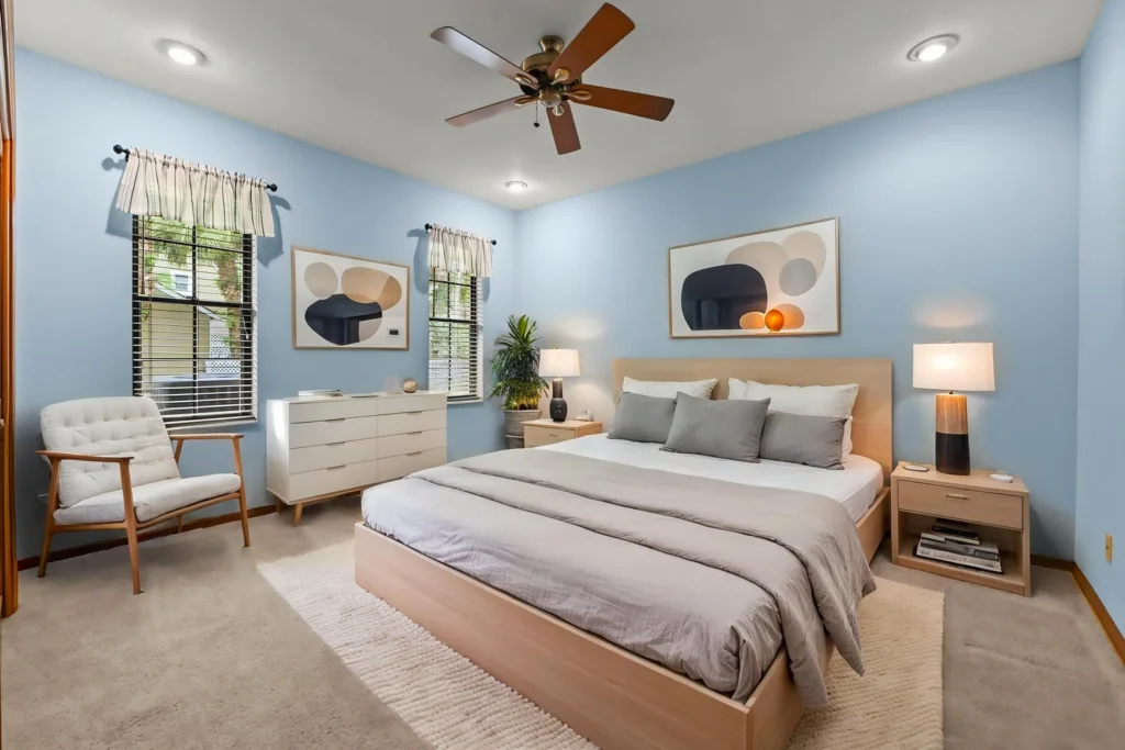 20260930222706482694000000-o - Lake Worth Homes - Lake Worth Homes Light blue bedroom with a wooden platform bed, gray bedding, and matching nightstands.