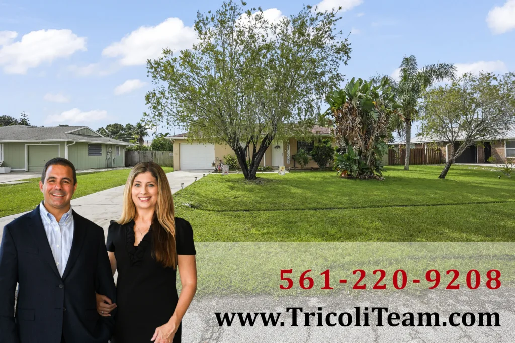 Homes for Sale in Port St Lucie FL 34952 5 - Lake Worth Homes - Lake Worth Homes Two professionally dressed people stand in front of a suburban house with a green lawn and trees; bright blue sky in the background. (people appear to be real estate agents)