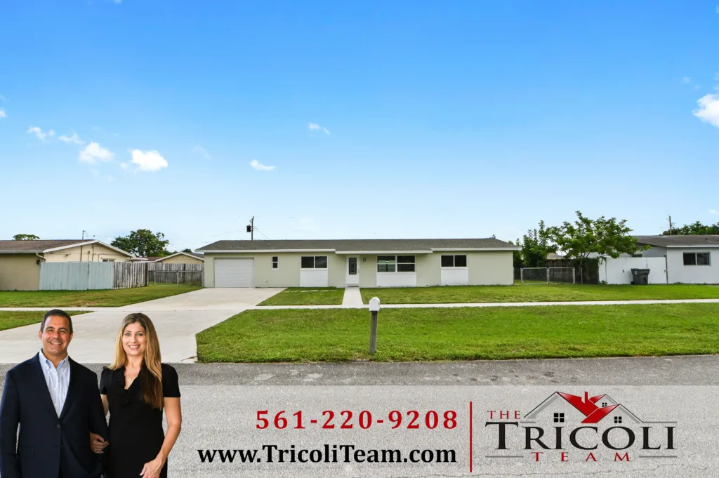Homes for Sale in Forest Hill Park West Palm Beach FL 33415 3 - Lake Worth Homes - Lake Worth Homes Two professionals in front of a suburban home on a real estate banner, with Tricoli Team branding in the foreground.